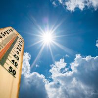 Thermometer Sun high Degres. Hot summer day. High Summer temperatures